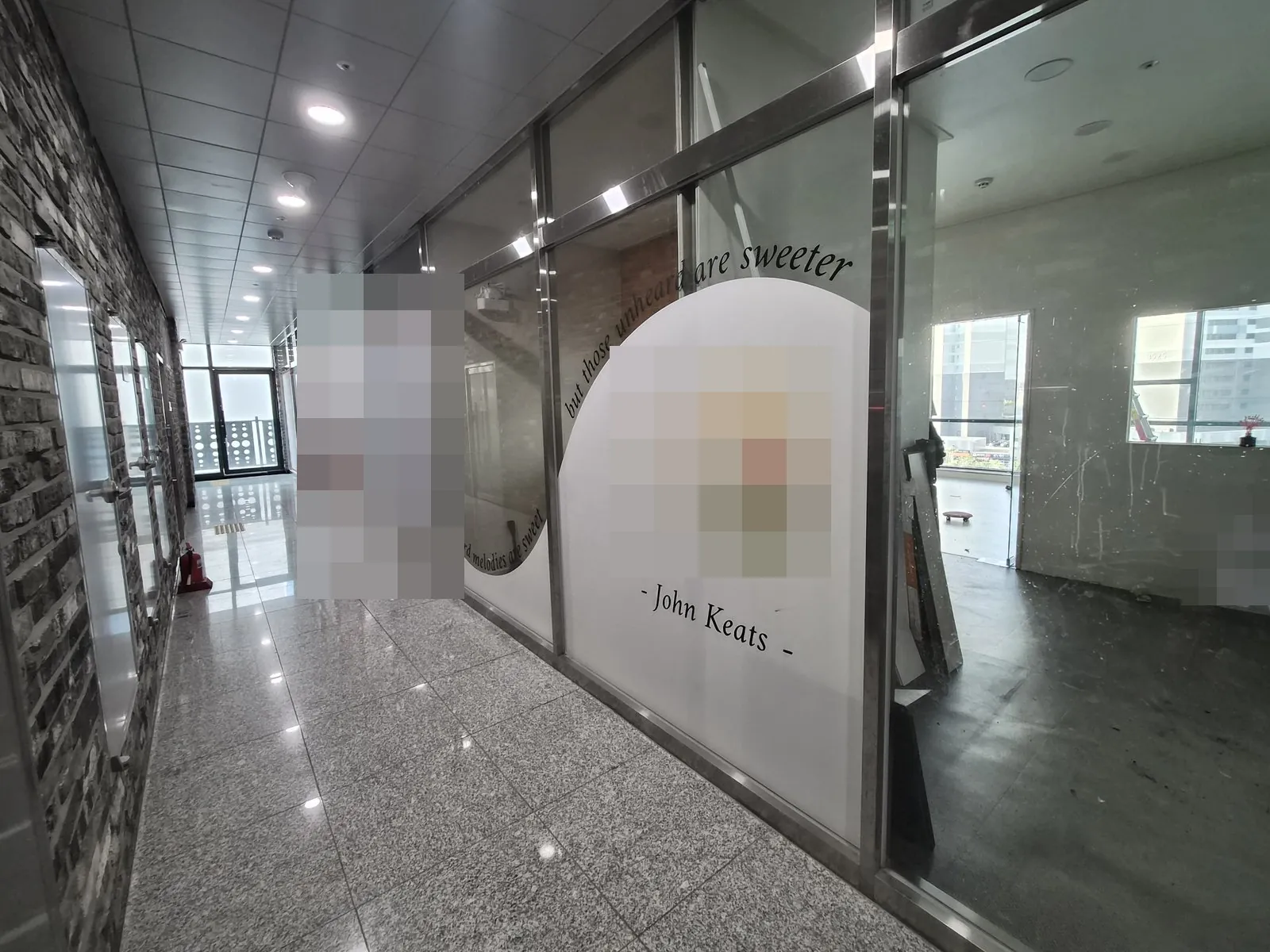 복도 옆 비워진 점포 내부와 유리 칸막이