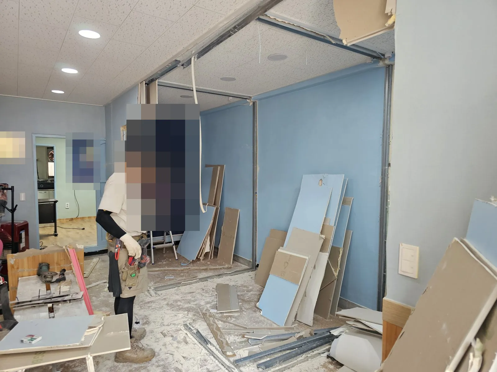 가벽 석고보드를 해체해 조각이 바닥에 쌓인 작업 현장