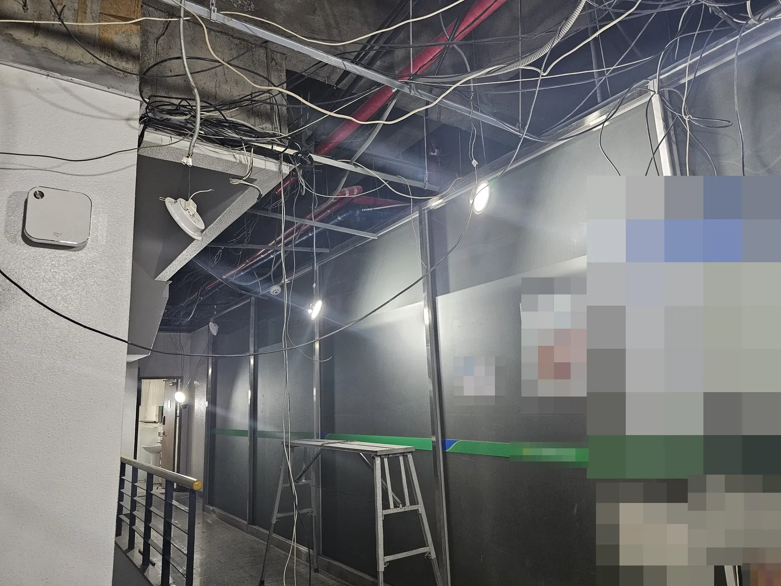 복도 천장재가 철거되어 배관과 전선이 노출된 모습
